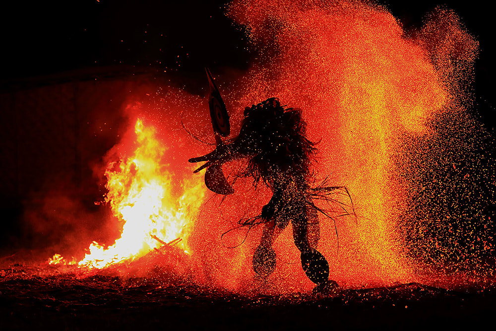 Baining fire dancer in the midst of the flames
